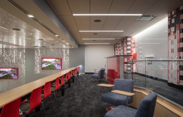 The entry level concourse features a raised viewing area with genius bar, comfortable seating, glass panels for brainstorming, and a branding graphic with a digital theme. 